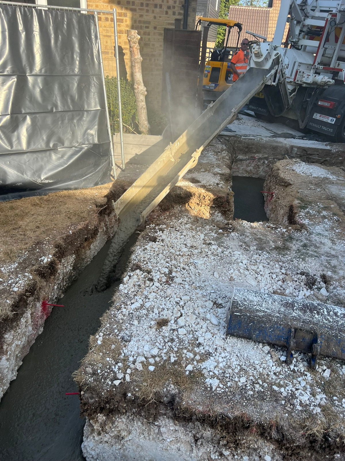 Concrete pump filling extension foundation trenches in Hampshire