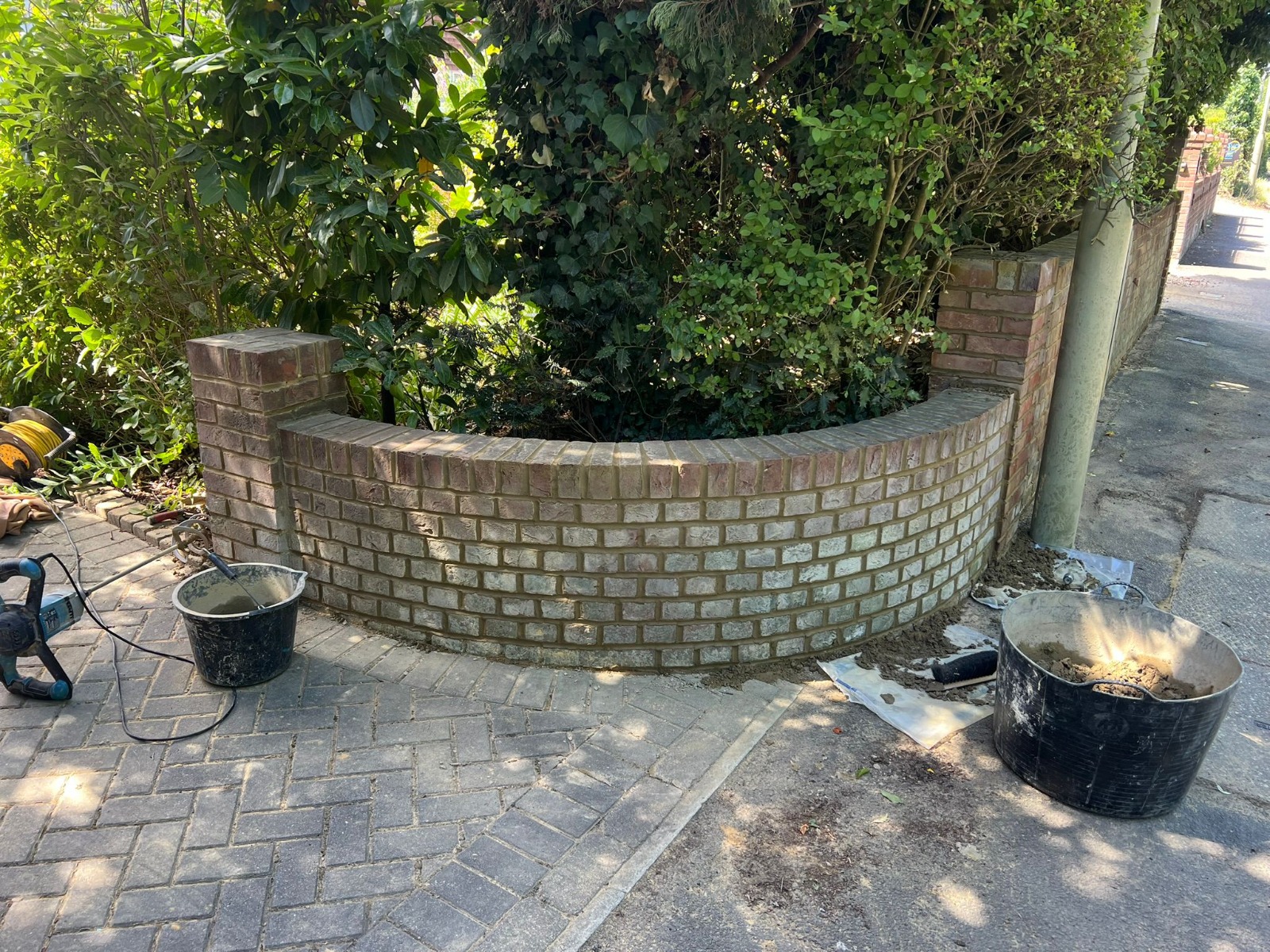 Curved red brick garden wall near Basingstoke