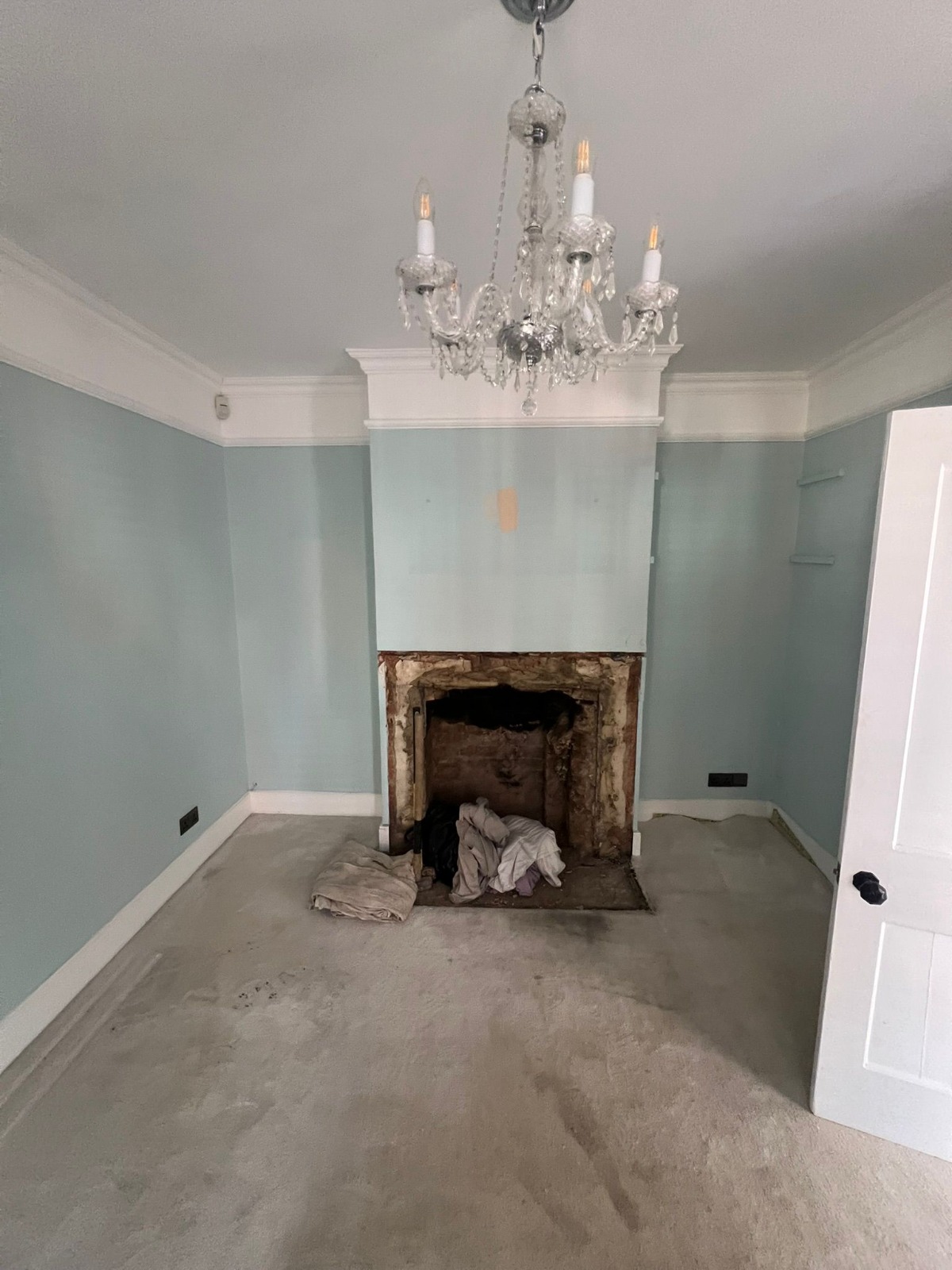 Room stripped back with the old fireplace opened up